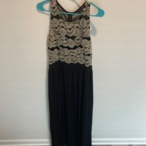 Evening wear. Black dress with gold sequin. There is a front slit